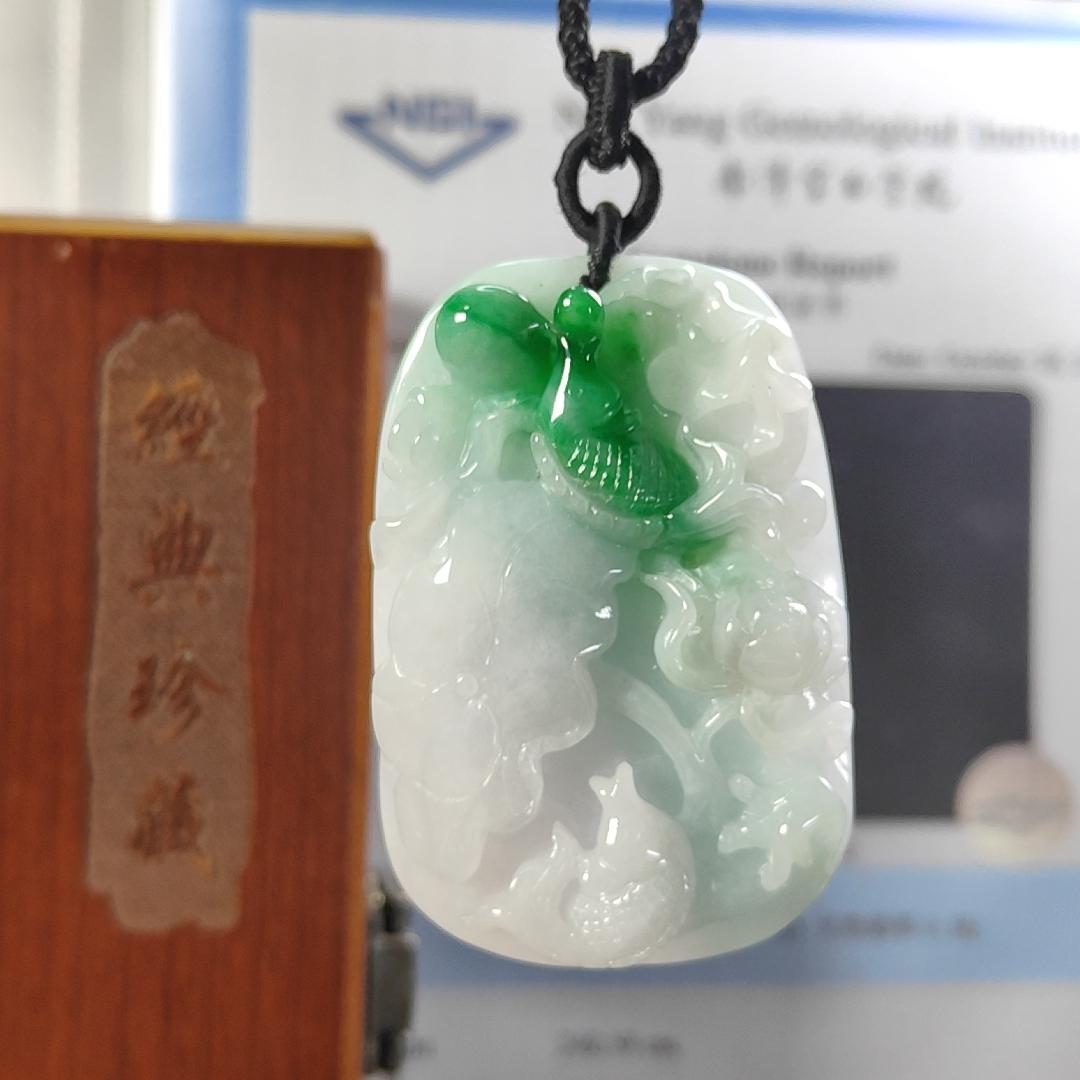 Carved with lotus fish Natural Type A Jadeite Pendant with Gemstone report from NGI - Weight 240.59 grams Measurement: 54.17 * 36.35 * 13.36 mm - Translucent with the Specify Gravity at 3.33 , Near white to faint green with green patches (pendant145) Yi Pin Qian
