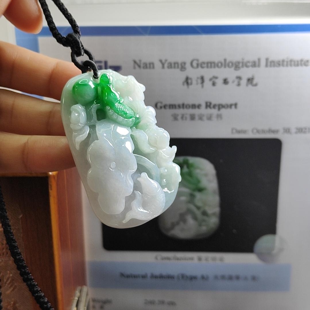 Carved with lotus fish Natural Type A Jadeite Pendant with Gemstone report from NGI - Weight 240.59 grams Measurement: 54.17 * 36.35 * 13.36 mm - Translucent with the Specify Gravity at 3.33 , Near white to faint green with green patches (pendant145) Yi Pin Qian