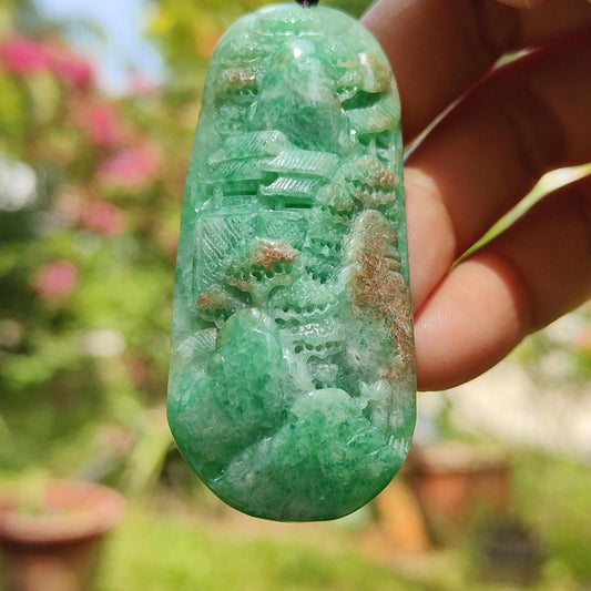 Green with patches of light brown Translucent Natural Type A Jadeite Pendant carved with scenery with NGI Gemstone report weight 126.07 grams, 60.73 * 27.79 * 9.53 mm , fine grain crystal aggregate, granular and fibrous interlocking texture (pendant142) Yi Pin Qian